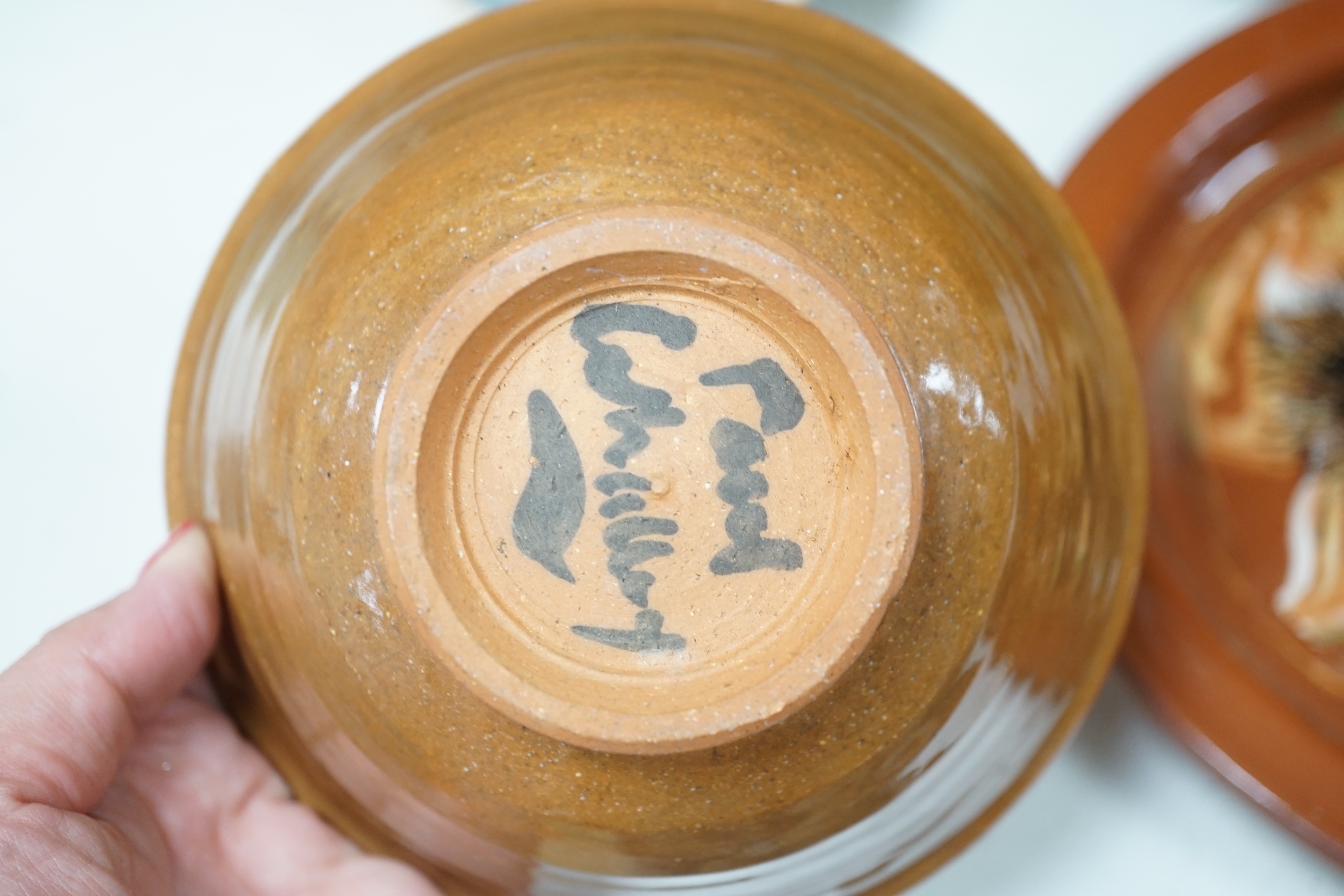 A group of European and Japanese studio pottery dishes, bowls and vases including a Boscastle R Irving plate, largest 26cm in diameter (17)